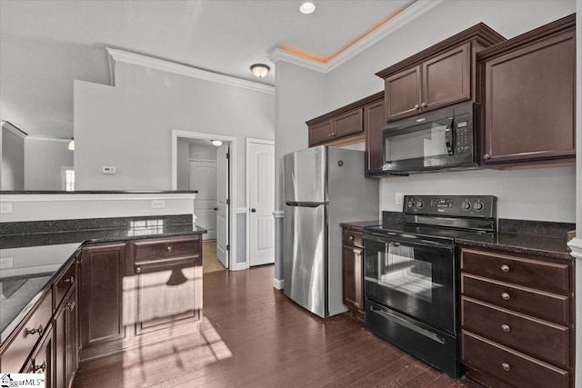 kitchen featuring dark hardwood / wood-style floors, dark stone counters, dark brown cabinets, black appliances, and ornamental molding