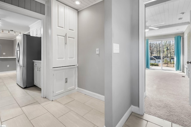 hallway with wood ceiling, light carpet, and track lighting