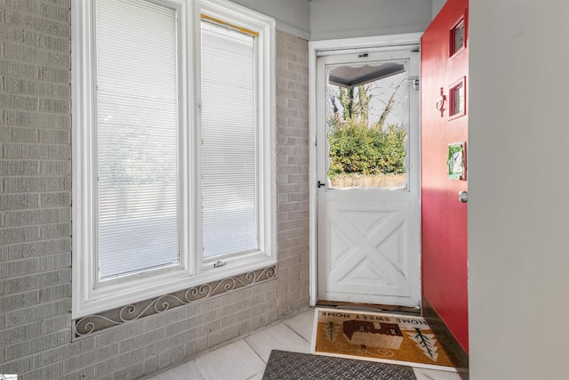 doorway with light tile patterned floors