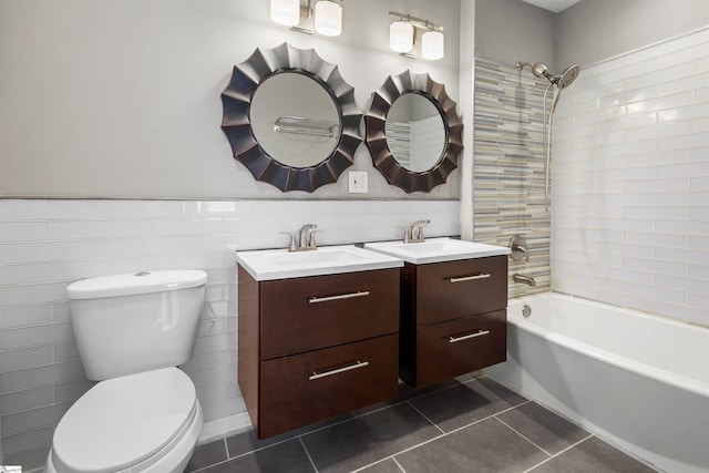 full bathroom featuring tile patterned flooring, vanity, tiled shower / bath combo, and toilet