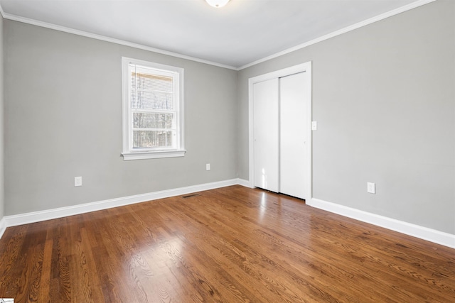 unfurnished bedroom featuring hardwood / wood-style flooring and ornamental molding