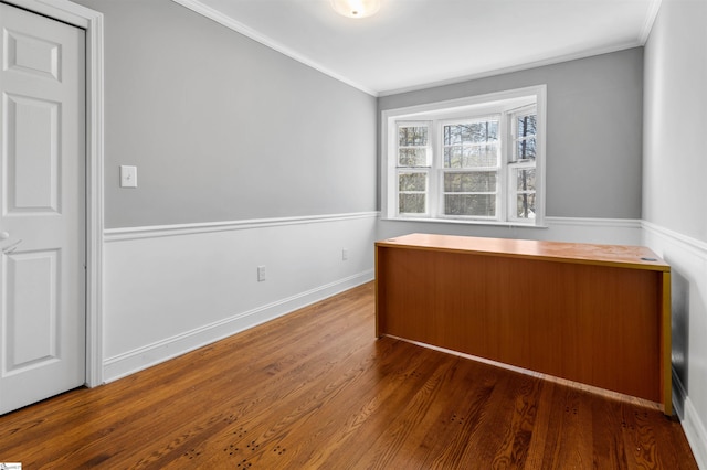 unfurnished office with dark hardwood / wood-style flooring and crown molding