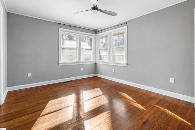 spare room featuring hardwood / wood-style flooring, ceiling fan, crown molding, and a wealth of natural light