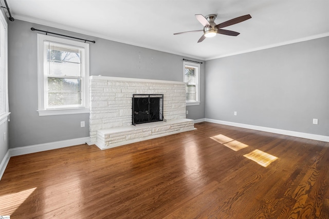 unfurnished living room with a fireplace, hardwood / wood-style flooring, ceiling fan, and ornamental molding