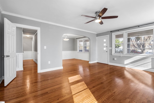 unfurnished living room featuring hardwood / wood-style flooring, ceiling fan, and ornamental molding