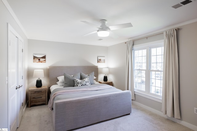 carpeted bedroom featuring ceiling fan and ornamental molding