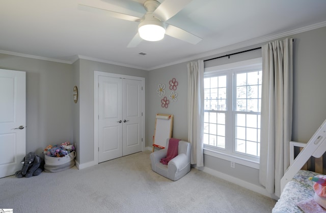 bedroom featuring ceiling fan, ornamental molding, light carpet, and a closet