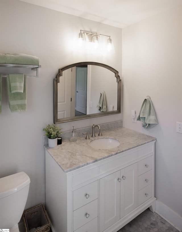 bathroom featuring vanity and toilet