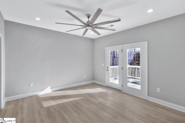 empty room featuring light wood-type flooring and ceiling fan