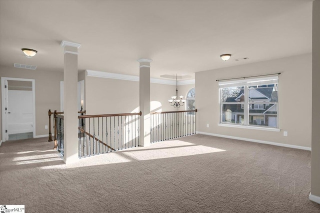 empty room featuring carpet floors, crown molding, and a notable chandelier