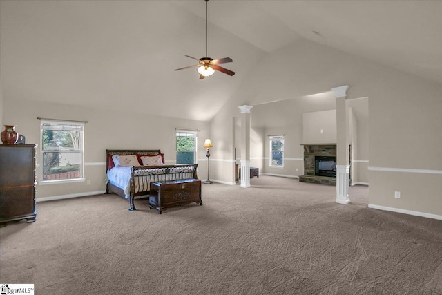 bedroom featuring ceiling fan, a fireplace, high vaulted ceiling, and multiple windows