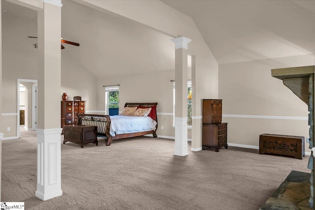 bedroom with decorative columns, ceiling fan, carpet, and high vaulted ceiling