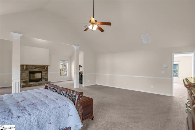 carpeted bedroom featuring ceiling fan, a stone fireplace, and lofted ceiling