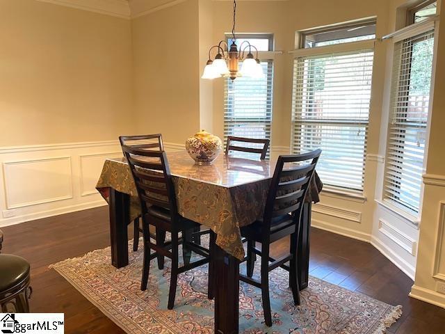 dining area featuring a notable chandelier and dark hardwood / wood-style flooring