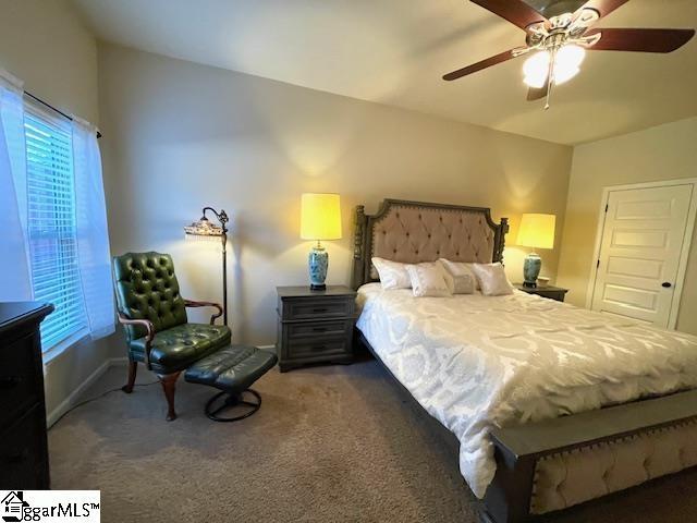 bedroom featuring dark colored carpet and ceiling fan