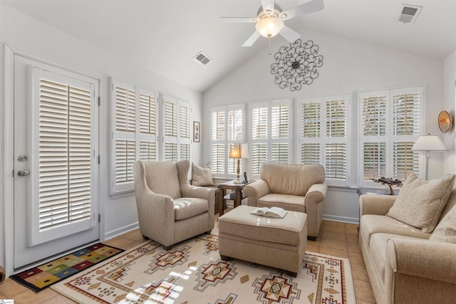 living area with light tile patterned floors, plenty of natural light, lofted ceiling, and ceiling fan