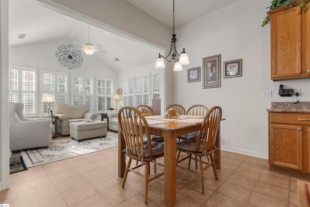 dining space with lofted ceiling, light tile patterned floors, and ceiling fan with notable chandelier