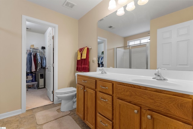 bathroom with toilet, vanity, and walk in shower