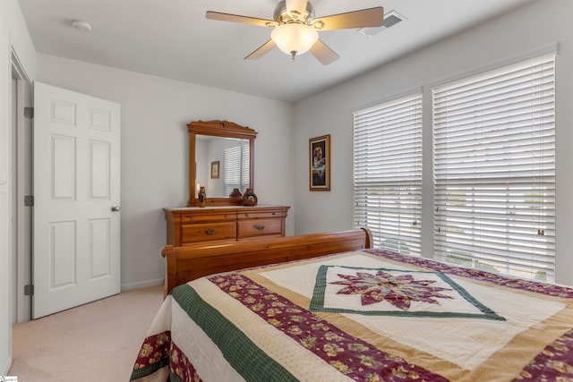 bedroom with light carpet and ceiling fan