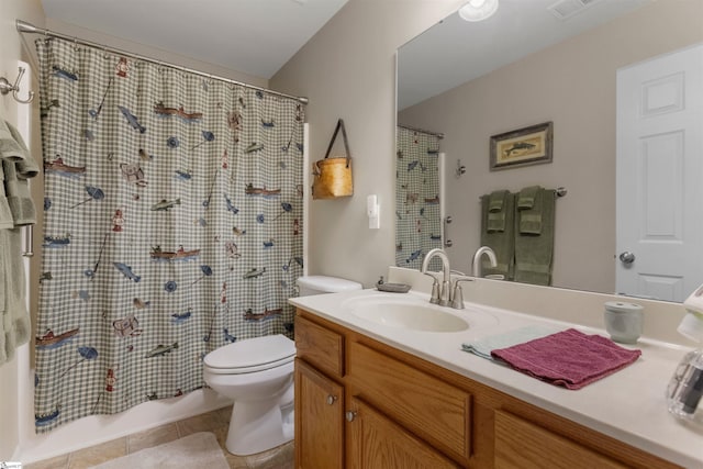 bathroom with toilet, vanity, and tile patterned floors