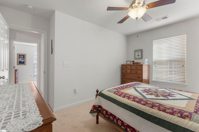 bedroom with light colored carpet and ceiling fan