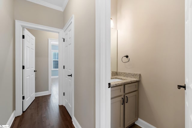 bathroom with wood-type flooring, vanity, and ornamental molding