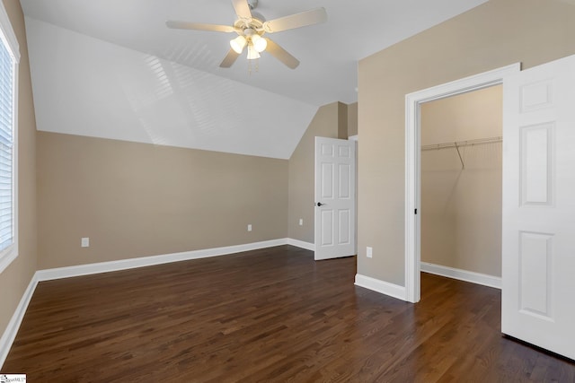 additional living space with dark hardwood / wood-style floors, vaulted ceiling, and ceiling fan