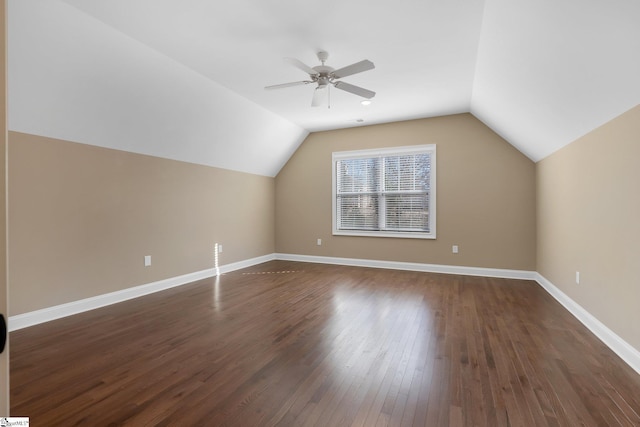 additional living space featuring ceiling fan, dark wood-type flooring, and lofted ceiling