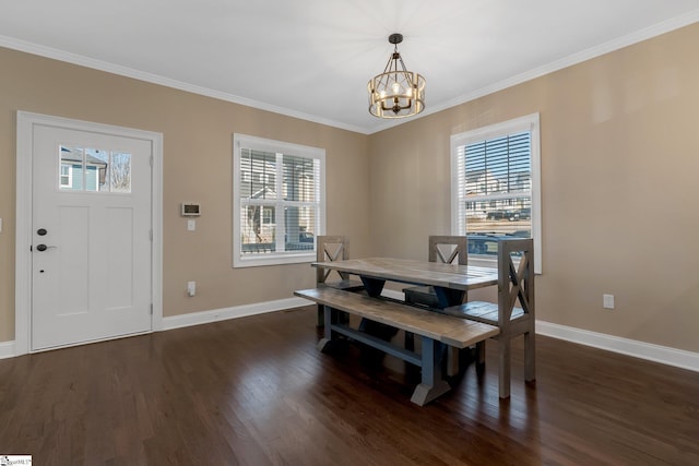 dining room featuring ornamental molding, dark hardwood / wood-style floors, and a notable chandelier