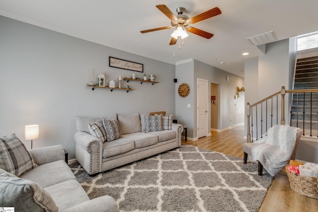 living room with light wood-type flooring and ceiling fan