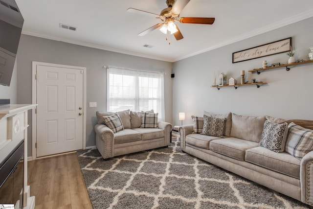 living room featuring ceiling fan, dark hardwood / wood-style floors, and crown molding