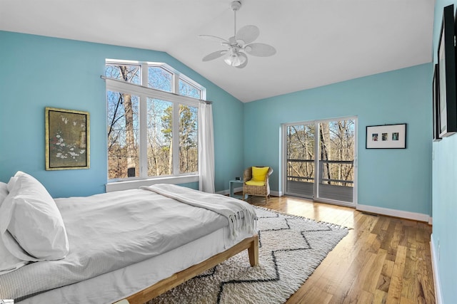 bedroom with ceiling fan, lofted ceiling, access to outside, and multiple windows