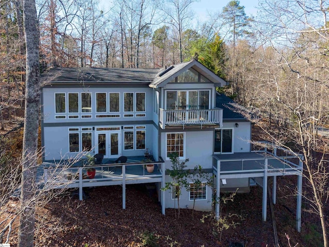 back of property featuring a wooden deck, french doors, and a balcony