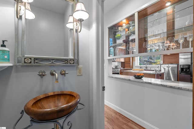 bathroom with wood-type flooring and sink