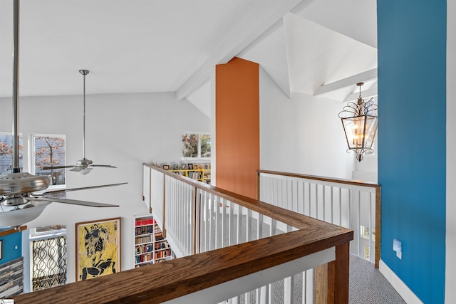 corridor featuring vaulted ceiling with beams, carpet floors, and a chandelier