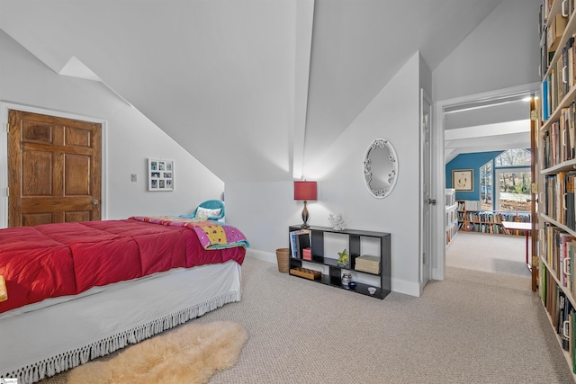 bedroom featuring carpet floors and lofted ceiling