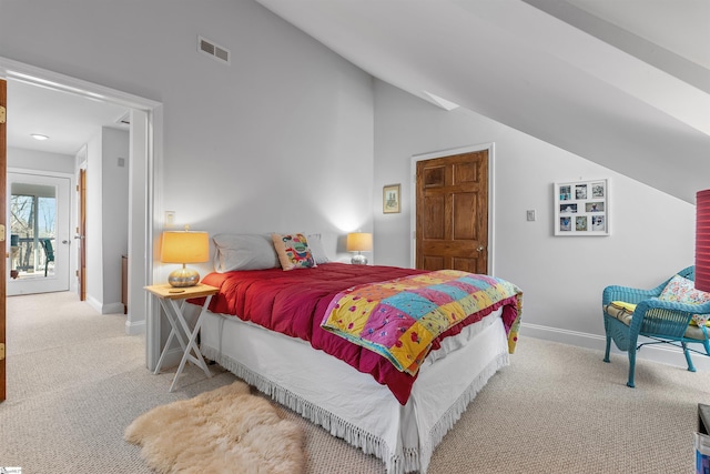 bedroom with light colored carpet and lofted ceiling