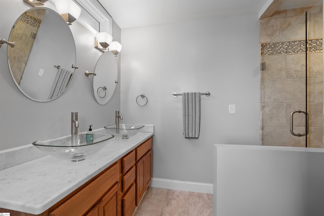 bathroom with tile patterned flooring, vanity, and a shower with shower door