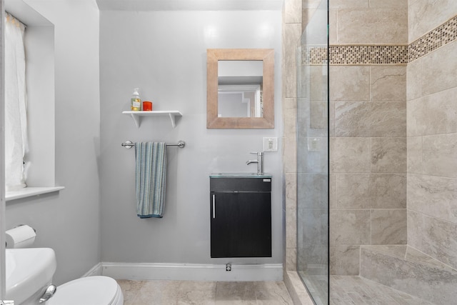 bathroom featuring tiled shower, vanity, and toilet