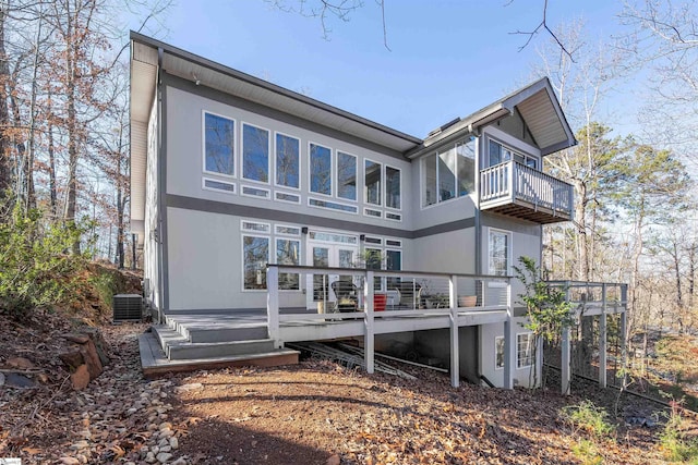 rear view of house with a balcony and a deck