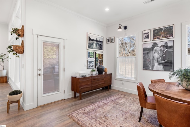 office area featuring hardwood / wood-style floors and ornamental molding