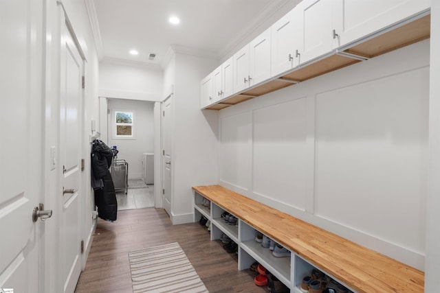 mudroom with crown molding, washer / clothes dryer, and dark wood-type flooring