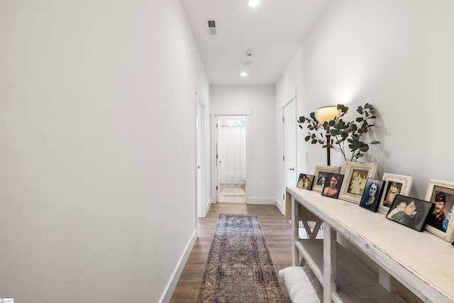 corridor with dark hardwood / wood-style flooring