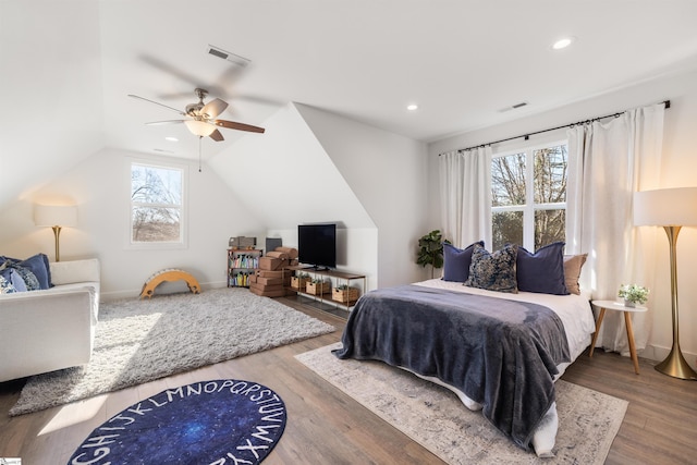 bedroom featuring multiple windows, wood-type flooring, vaulted ceiling, and ceiling fan