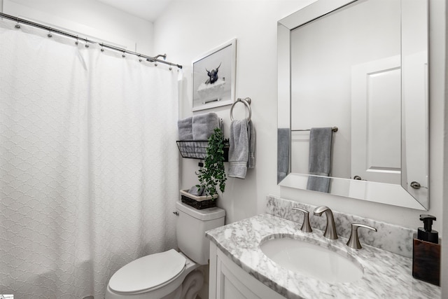 bathroom with vanity, toilet, and walk in shower