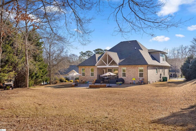 rear view of property with a lawn and a patio