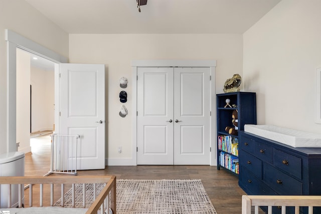 bedroom featuring dark wood-type flooring and a closet