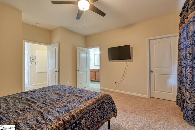 bedroom with connected bathroom, ceiling fan, and light colored carpet