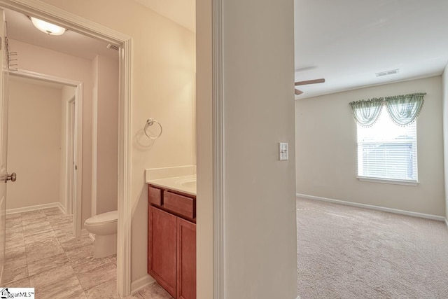 bathroom featuring ceiling fan, vanity, and toilet