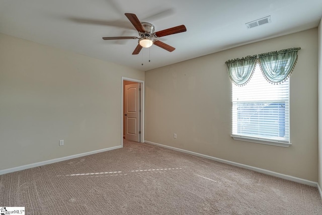 unfurnished room with plenty of natural light, ceiling fan, and light colored carpet